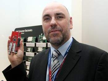 《圖二十 英特爾數位家庭事業群解調器與調諧器部門行銷主任Richard Crossley手持Intel CE 6250Dual Channel COFDM Demodulator。》
